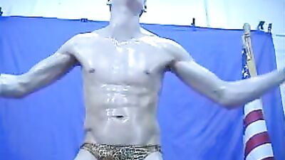 Oiled up twink flexing in hot gay action