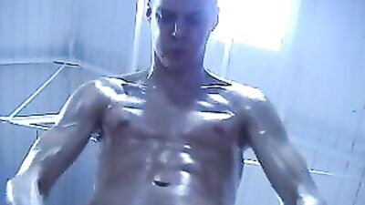 Oiled up twink flexing in hot gay action