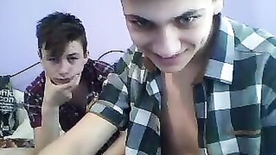 Two boys play on the bed