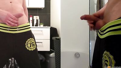 teen boy is urinating in the bathroom