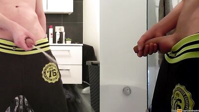 teen boy is urinating in the bathroom