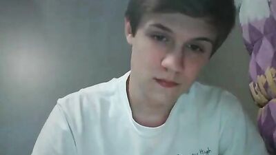 Attractive young boy masturbating on her bed