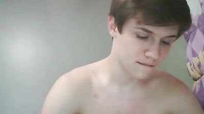 Attractive young boy masturbating on her bed