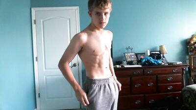 Cute blonde teen flexes his hard muscles