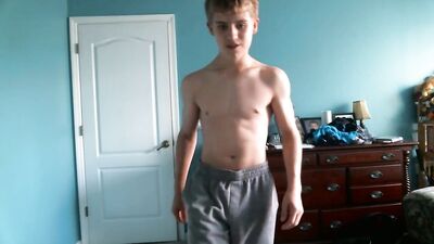 Cute blonde teen flexes his hard muscles
