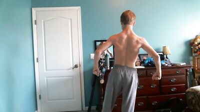 Cute blonde teen flexes his hard muscles