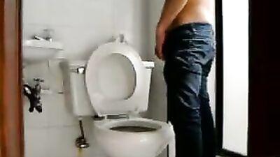 Boy piss and wanks in toilet
