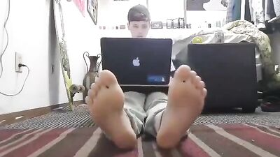 Young boy teases with his feet