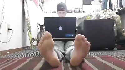 Young boy teases with his feet