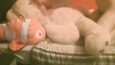 Boy plays with teddy stuffed animals