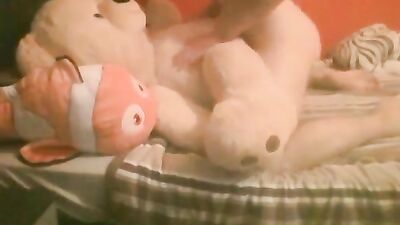 Boy plays with teddy stuffed animals