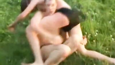 Young shepherds wrestling on the pasture