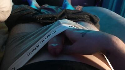 A young guy caresses his dick