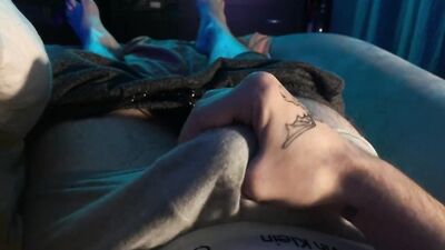 A young guy caresses his dick