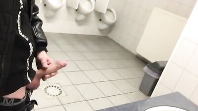 Jerking off in a public toilet
