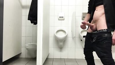 Jerking off in a public toilet