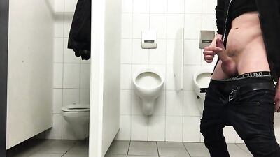 Jerking off in a public toilet