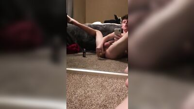 A boy is dildoing sitting on the carpet