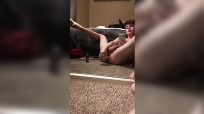 A boy is dildoing sitting on the carpet