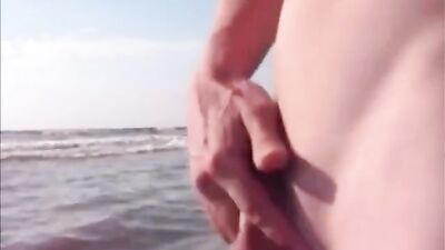Twink jerking and cumming in the sea