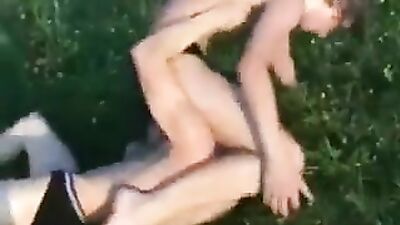 2 boys wrestle shirtless oustide(Lions, tigers & no bears )