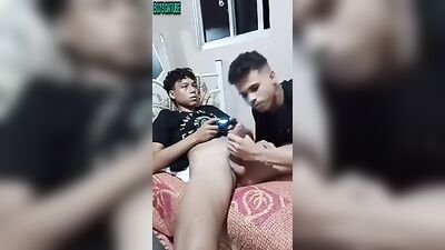 Latino Passion: Friendly Latino Boy Plays Game while Sucking and Jacking Off his Pal!