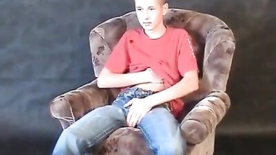 Gay Teen Jerks Off in Armchair! This erotic video features a hot young lad who strips down to his underwear and jerks off until he cums all over himself. A must-see for any gay porn fan!
