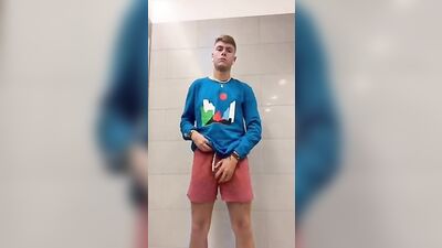 Self-confident blonde risks a public restroom wank with muscular boys