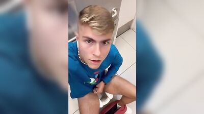 Self-confident blonde risks a public restroom wank with muscular boys