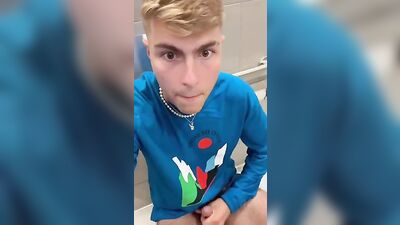 Self-confident blonde risks a public restroom wank with muscular boys