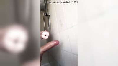 The cutie shows off his big, uncut cock in the shower
