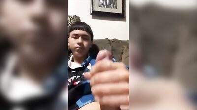 Latino solo twink jerks and cums on his hand in the bedroom
