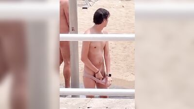 Sexual Adventure on the Beach: A Naked Hung Man Showering under Watchful Eyes