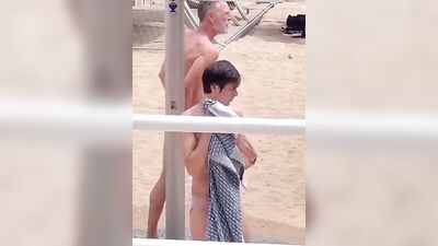 Sexual Adventure on the Beach: A Naked Hung Man Showering under Watchful Eyes