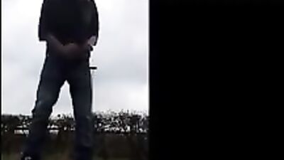 Gay amateur twink college jock showers on campus lawn, strokes his cock then shoots load in the open air