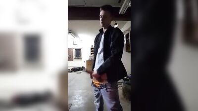 Young stud with a big dick pleasures himself in the garage while enjoying his own semen