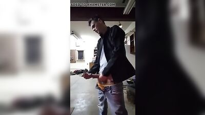Young stud with a big dick pleasures himself in the garage while enjoying his own semen