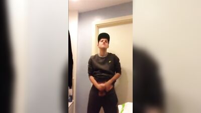 Handsome Young Man Chatting on Phone While Stripping Down