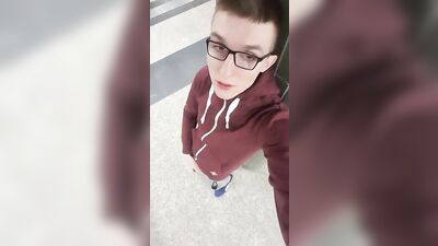 Handsome nerdy guy pleasures himself on a crowded street