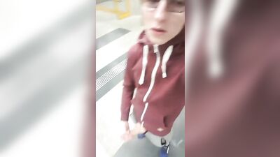 Handsome nerdy guy pleasures himself on a crowded street