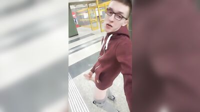 Handsome nerdy guy pleasures himself on a crowded street