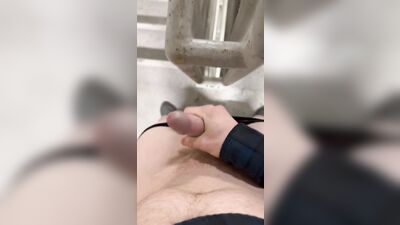 Twink jerks off in parking garage and blows load