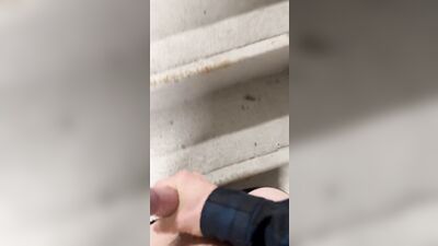 Twink jerks off in parking garage and blows load