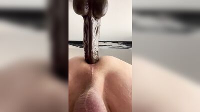 Fucking a 10” dildo.