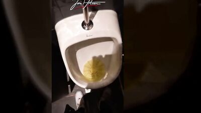 This handsome boy pisses pee in a public urinal in a crowded restaurant. Jon Arteen gay porn video