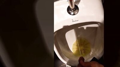 This handsome boy pisses pee in a public urinal in a crowded restaurant. Jon Arteen gay porn video