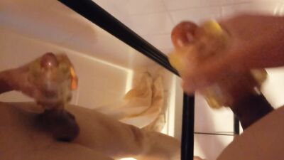Nude twink wanks his big hard dick with an oiled Fleshlight, cums on a mirror, moans in the bathroom