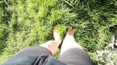 Jon Arteen walks barefoot on the grass, shows the soles of his feet in close-up, does the giant feet