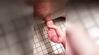 Gay twink reaches under for some bathroom fun