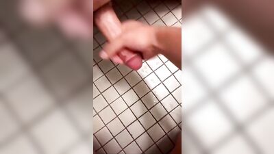 Gay twink reaches under for some bathroom fun
